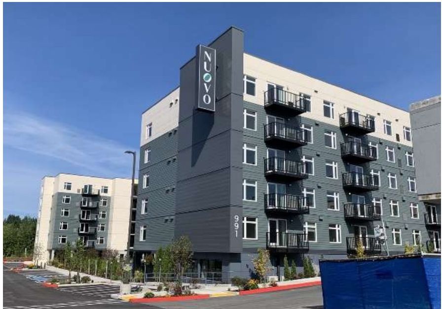 Aerial view of a completed five-story apartment community in Bellevue, Washington